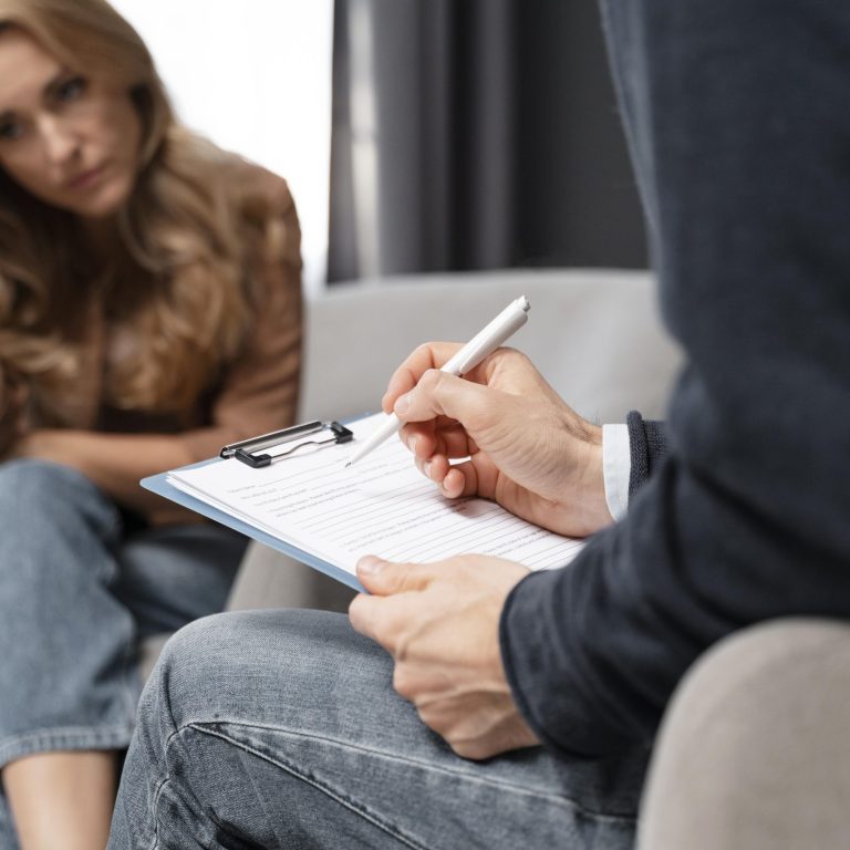mid-shot-man-therapist-taking-notes-near-woman